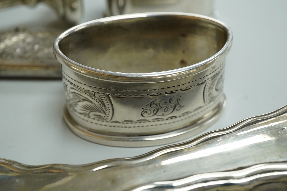 Three assorted silver napkin rings, a pair of recent 925 napkin rings, a George V silver mounted hand mirror, a modern silver mounted spill vase and a late Victorian silver vesta case.